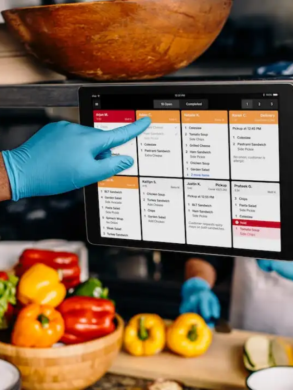 Kitchen employee clicking kitchen display.