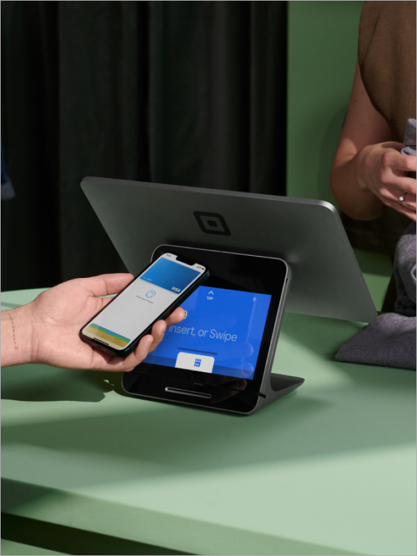 Customer paying on Square register with mobile pay.