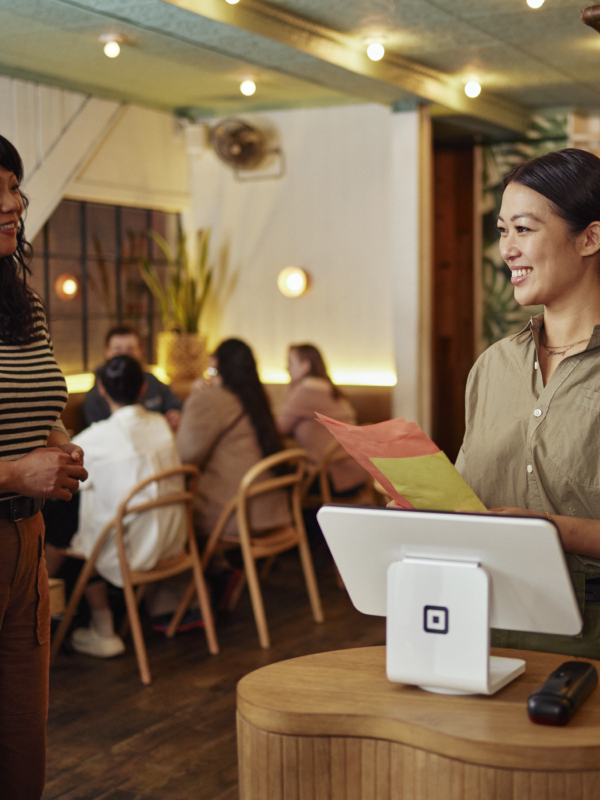 Restaurant host welcoming guest.