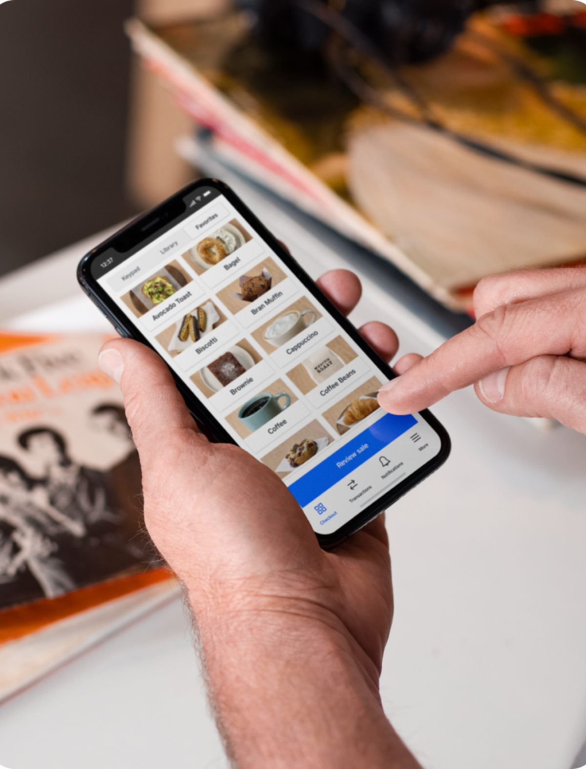 Person placing order on Square mobile app.